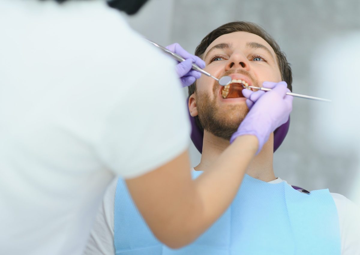 Periodontal,Services.,Closeup,Shot,Of,Smiling,Man,Getting,Treatment,In